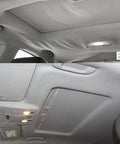 Two-panel view of car headliner repair: crumpled gray headliner before and smooth gray headliner after.