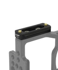 Heavy Duty Quick Release NATO Rail Plate With 1/4 20 Screws mounted on camera cage, featuring two gold locking pins.
