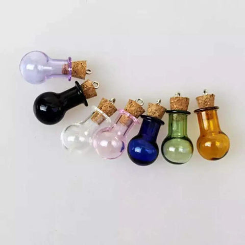 Colorful glass potion bottles with cork stoppers for crafts, featuring purple, black, clear, pink, blue, green, and yellow designs.