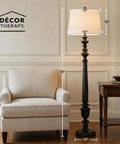 Benjamin Traditional Floor Lamp Satin Black Finish With Resin Construction next to armchair, offering classic charm in living room.