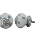 Close-up of white ceramic drawer knobs with green polka dots, rust proof backing for 100 Pack Ceramic White Polka Dot Drawer Knobs Rust Proof Heavy Duty Kitchen Cabinet Pulls For Dressers Smooth Edge Zero Hassle Setup Snazzy Home Decor Hardware Upgrade Refresh.