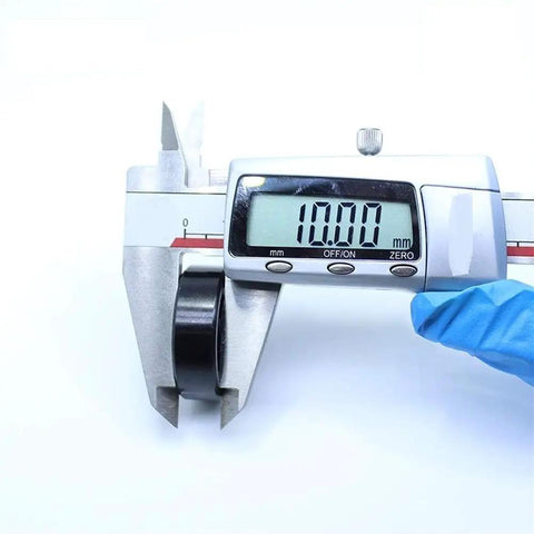 Heavy Duty TB6201 High Temp Full Ball Bearing 12X32X10Mm Rated To 500C measuring 10mm with digital caliper for accurate specs.