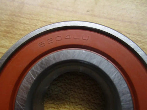 Close-up of 6204 Deep Groove Ball Bearing featuring 20 mm bore and red rubber seal for shop and auto repairs.