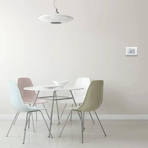 Interior room with wall-mounted Renewed Non Programmable Thermostat With Simple Single Degree Control, precise accuracy.