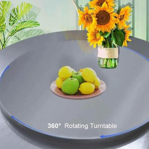Slick Heavy Duty Stainless Steel Lazy Susan Rotating Turntable for Dining Tables with fruits and sunflowers displayed.