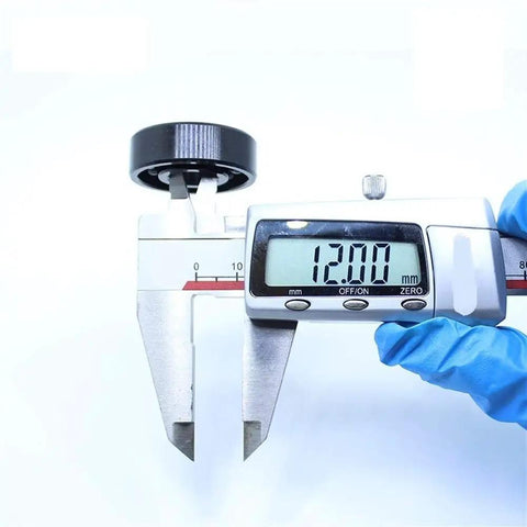 Measuring a Heavy Duty TB6201 High Temp Full Ball Bearing 12X32X10Mm Rated To 500C with digital calipers showing 12mm.