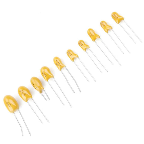 Badass Tantalum Capacitor Assortment Kit Featuring Ten Value Variations In A Nifty Labeled Storage Box, yellow capacitors arranged in a row.