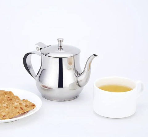 Mini 360Ml Stainless Steel Teapot For Tea And More beside a cup and toast, showcasing its sleek modern look and compact size.