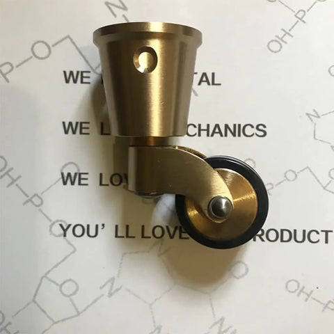 Solid Brass Swivel Castor Wheels With Smooth Rubber Glides For Heavy Furniture Vintage Antique Dining Chair Casters close-up view of brass and rubber wheel