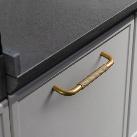 Six Pack 5 Inch Champagne Bronze Knurled Cabinet Pulls With Crosshatch Knurling for kitchen cabinets, showing a close-up installed view.