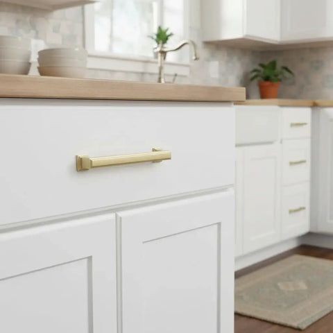 Give Your Home a Chic Glow Up with These Epic Brushed Gold Cabinet Pulls Hardware 10 Pack 5 Inch Handles for Kitchen Cabinets Drawers and Wardrobes Solid Metal Fit on white cabinet drawer.