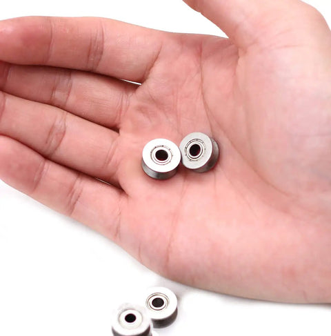 10 Pack V624ZZ Sealed Ball Bearings And V Groove Guide Pulleys Top Shelf Bearing Steel For Smooth Sliding Doors And Steering Systems Featuring A Tight Four Millimeter Inner Bore And Compact 3 X 13 X 6 Millimeter Profile held in a hand.