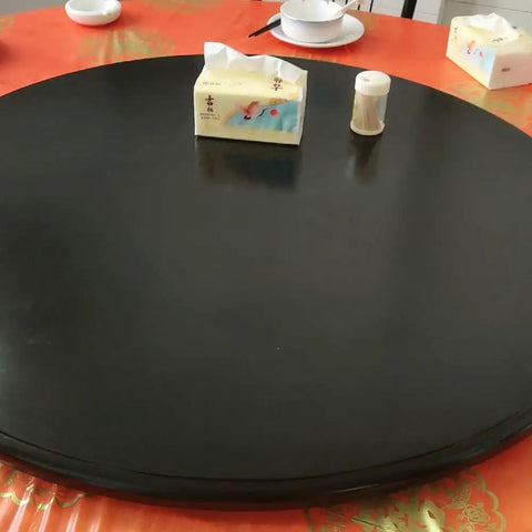 Multi Color Wooden Lazy Susan Round Rotating Serving Tray A Smooth Operator For Dining Tables And Kitchen Counters A Real Deal Hosting Game Changer With Easy Spin Action In Black on a dining table with condiments.