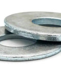 Heavy Duty Zinc Plated Flat Washers Us Spec 2 5/8 Inch Central Opening Over 5 Inch Outer Edge Point Two Four Five Thick Steel Pack Of One Hundred close-up view of two zinc plated flat washers.