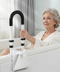 Rock Solid Adjustable Bathtub Safety Rail And Grab Bar Handle With Non Skid Grip For Steady Balance clamp installed on a tub with a senior using it.