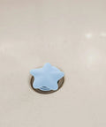 2pcs Silicone Star Shaped Bathtub Stopper Flat Cover for Drain Plug in light blue, placed over bathtub drain.