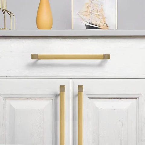 Kickass Zinc Alloy Cabinet Pulls Featuring Slick Brushed Gold Finish For Kitchen Drawers And Bathroom Vanities on white cabinets.