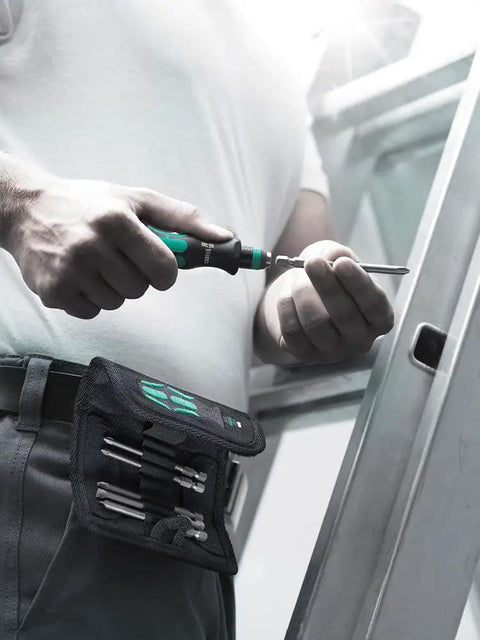 Technician using Kraftform Bitholding Screwdriver With Rapidaptor, wearing a 3.5 inch bit pouch with 6 long bits for quick bit swaps.