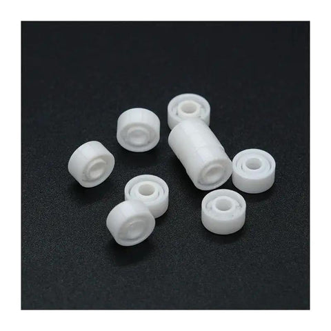 Top Shelf Zirconia Ceramic Ball Bearings Built Solid For Demanding Workshops on black surface, featuring white ceramic design.