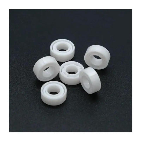 Top Shelf Zirconia Ceramic Ball Bearings Built Solid For Demanding Workshops, set of six white ball bearings for various machinery.