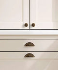 Straight Up 10 Pack Sunflower Cabinet Cup Pulls In Antique Brass Finish on kitchen cabinet and drawers with modern design.