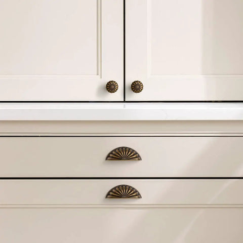 Straight Up 10 Pack Sunflower Cabinet Cup Pulls In Antique Brass Finish on kitchen cabinet and drawers with modern design.