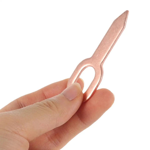 Person holding a piece from 200 Pieces Iron Dent Puller Rings For Auto Body Repair And Sheet Metal Dents Removal Car Panel Alignment Kit