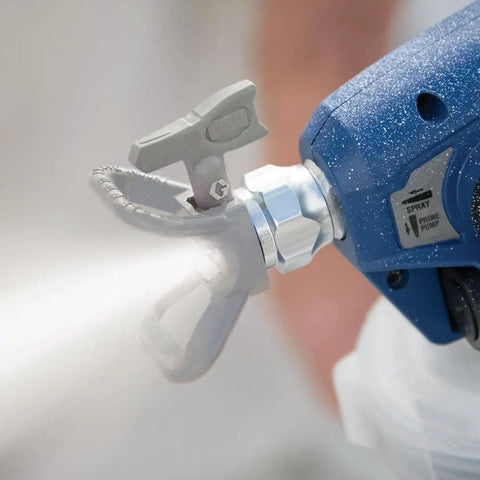 Professional Corded Airless Paint Sprayer With Triax Triple Piston Pump And Smart Control Dial spraying fine mist from nozzle.