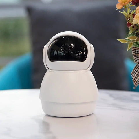 Top Tier 1080p AI Indoor Security Camera Featuring Sharp Human And Pet Motion Tracking Pan And Tilt Sweep For Effortless Home Crib Surveillance That Keeps Your Setup Locked Down Tight, white, compact design on a table.