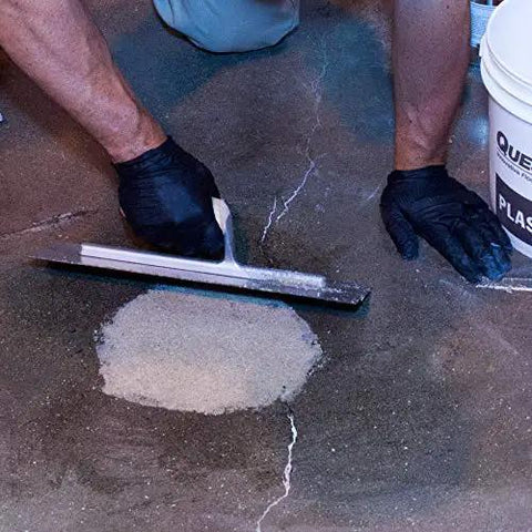 Applying Quick Setting Epoxy Concrete Floor Patch Two Gallon Light Gray Rapid Cure Mix to repair a concrete floor.