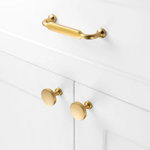 Premium Solid Metal Brushed Gold Cabinet Pulls on white drawers, heavy duty design with round knobs and sleek finish.