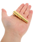 Hand holding a small gold-colored welder tool, part of Dent Puller Kit With Versatile Application And Easy Operation Heavy Duty Iron Material Welder Tool