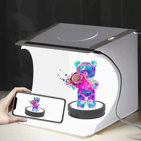 Heavy Duty 360 Rotating Display Stand With Killer Led Base And Remote Control Non Slip Photography Turntable For Jewelry Glass Artwork Retail Merchandise Total Showstopper Flex showcasing colorful bear figurine with flowers.