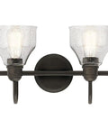 Avery 14.75 Inch Two-Light Vanity Light With Clear Seeded Glass In Olde Bronze, installed on a wall with lights on.