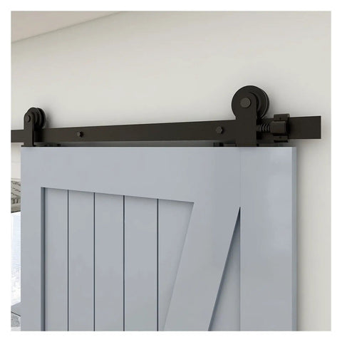 Built Tough Barn Door Hardware Kit 4 Foot Sliding Rail System with smooth glide and stylish black brackets mounted above the door.