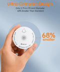 Hand holding ultra compact wireless smoke detector, measuring 2.75 inches, featuring ten year battery life and seamless RF linked alerts.