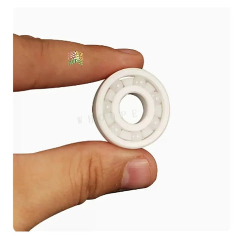 High Performance Hybrid Ceramic Bearings Double Sealed For Skateboards And Bikes, 6201 size in hand, showcasing white ceramic material.