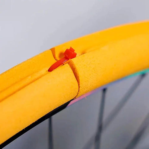 Close-up of orange air insert liner foam in a tubeless tire for 700c, 27.5 and 29 road bikes, providing puncture proof and rim protection.