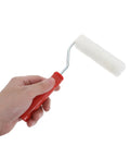 Hand holding a mini paint roller from the Mini Paint Roller Kit With Splash Guard Mixing Tray For Interior Wall Touch Ups Baseboard Painting And Small Surface Decor Quick Snap Setup For Flawless Smooth Finish Weekend Warriors.