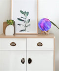 Top Shelf Natural Agate Stone Knobs With Gold Plated Edges For Cabinet Drawers And Furniture Doors on a white cabinet.