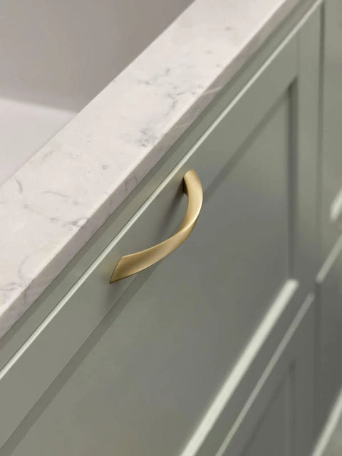Top Notch 5 Inch Arch Cabinet Pulls Featuring Brushed Gold Zinc Alloy Build on a green cabinet with a marble countertop.