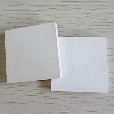 Boron Nitride Ceramic Square Sheet High Purity 99 Percent For Heat Sink Gasket And Lab Insulation Top Tier For Scientific Research 1mm By 100mm By 100mm With Excellent Thermal Conductivity And Electrical Insulation, shown in a stack on a wooden surface.