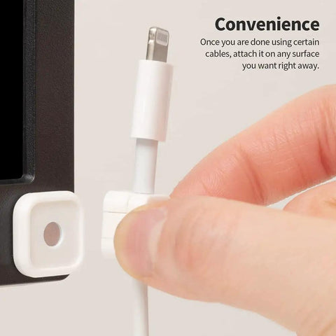 Hand attaching cable to Magnetic Cable Clips 3 Pack For Car And Office Cable Management Self Adhesive Cable Organizer Clips Black