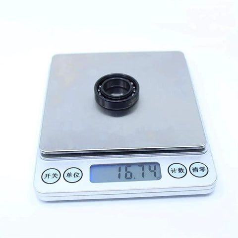 2Pcs Rugged Workhorse Full Ball Thin Section Bearings TB6903 on digital scale showing weight 16.74g, precision engineered for industry.