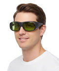 Top Shelf 800 To 1100Nm Laser Safety Goggles worn by a man, featuring black frame and yellow lenses for eye protection.