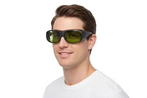 Top Shelf 800 To 1100Nm Laser Safety Goggles worn by a man, featuring black frame and yellow lenses for eye protection.