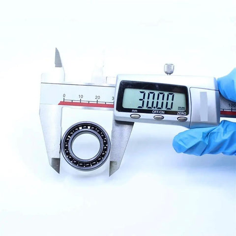 Pack Of Two High Temperature Thin Section Ball Bearings 17X30X7MM Rated For 500C Operation Heavy Duty being measured with calipers.