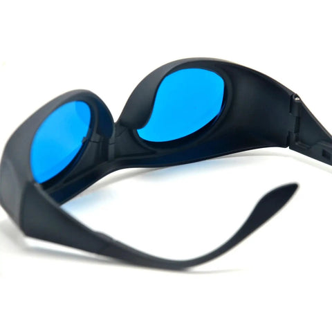 Kickbutt CE Certified IR Laser Safety Goggles With No Cap OD6 Plus Protection For 600 To 1100Nm Wavelengths blocking 808Nm 980Nm and 1064Nm angled view with blue lenses.