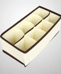 Top Tier Setup For Messy Drawers This Foldable Beige Drawer Organizer with eight compartments for sorting socks.