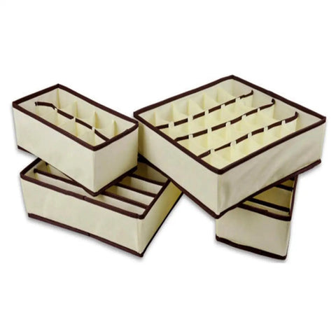 Four Piece Plastic Drawer Organizers With Six Seven Eight Compartments In Warm Beige for closet sorting and office cleanup.